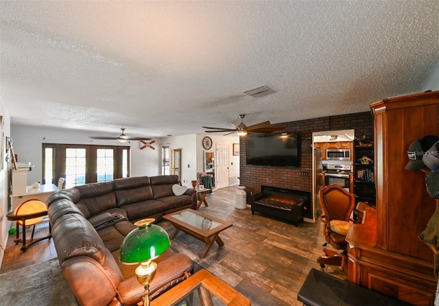 living room featuring ceiling fan, dark wood-type flooring, a brick fireplace, and visible vents