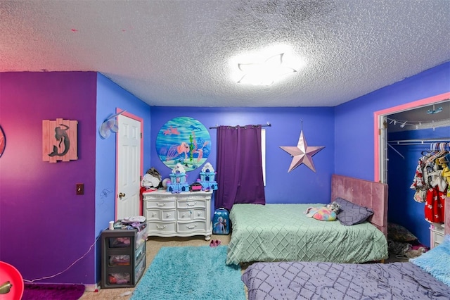 carpeted bedroom with a closet and a textured ceiling