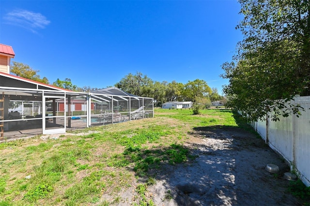 view of yard featuring a fenced in pool and a lanai