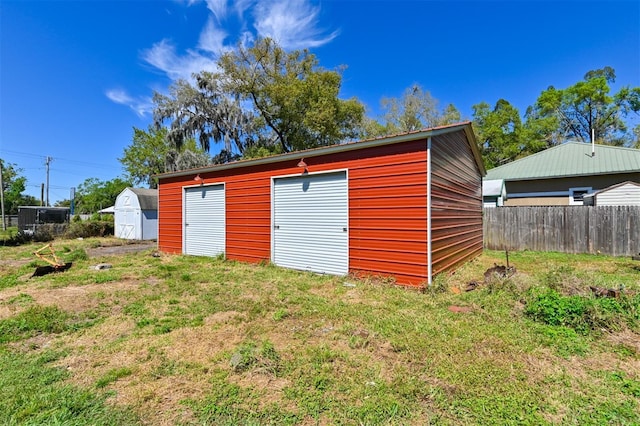 view of outbuilding with an outdoor structure and fence