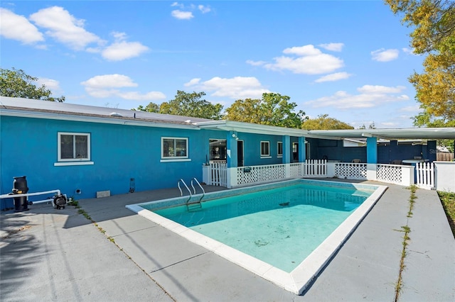 view of swimming pool featuring a fenced in pool, a patio, and fence