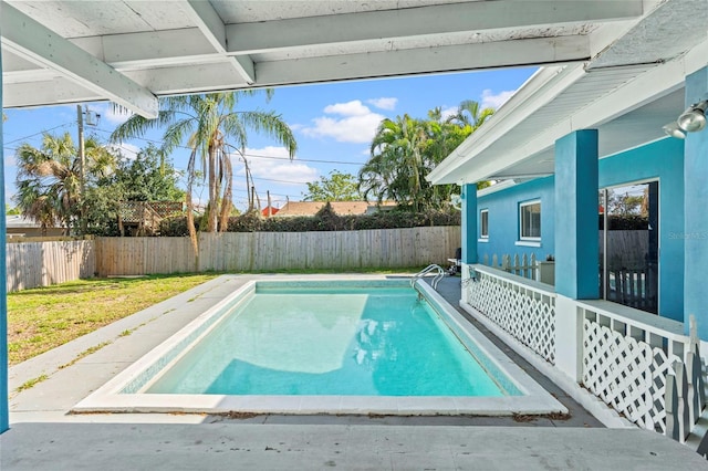 view of swimming pool with a lawn, a fenced in pool, and a fenced backyard