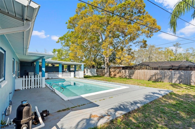 view of swimming pool with a fenced backyard, a fenced in pool, a yard, and a patio