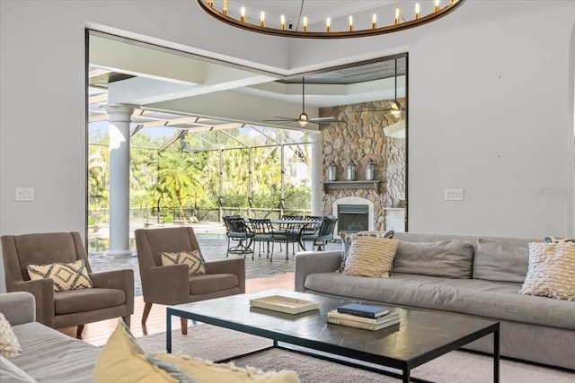 living area with a fireplace and a ceiling fan