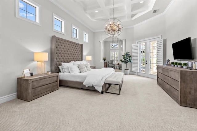 bedroom with a chandelier, light colored carpet, a towering ceiling, and access to outside