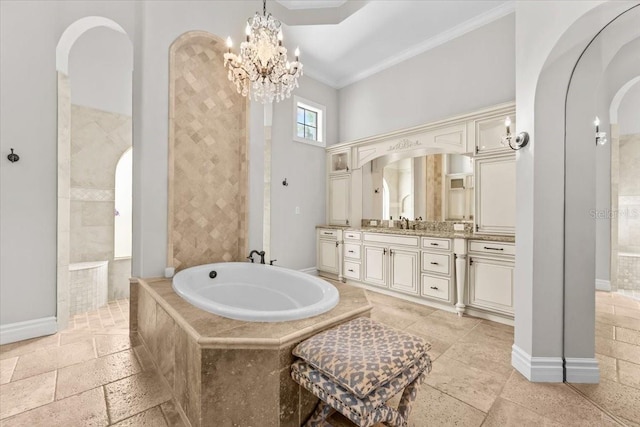 bathroom featuring crown molding, stone tile floors, a garden tub, and baseboards