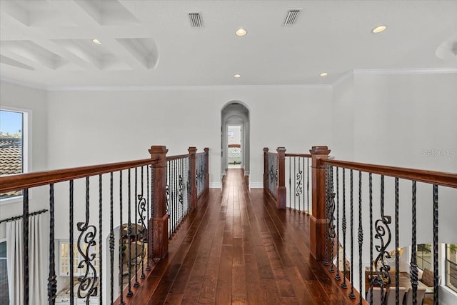 corridor with arched walkways, visible vents, recessed lighting, and hardwood / wood-style floors