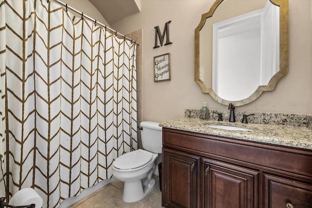 bathroom featuring tile patterned floors, toilet, a shower with shower curtain, and vanity