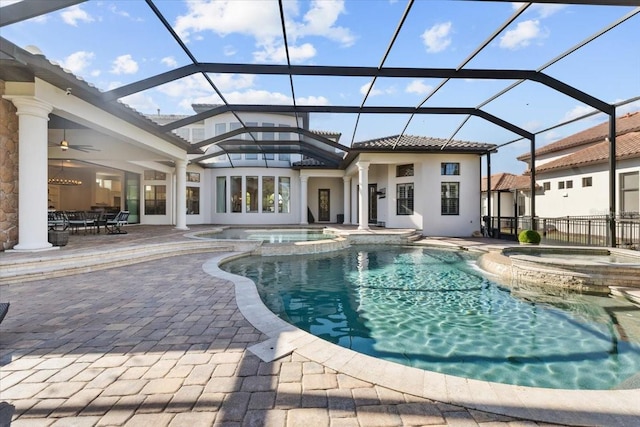 view of swimming pool with a lanai, a pool with connected hot tub, and a patio