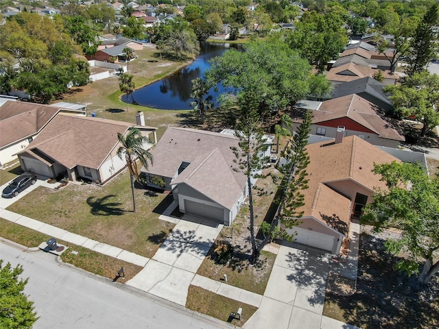 drone / aerial view with a residential view and a water view