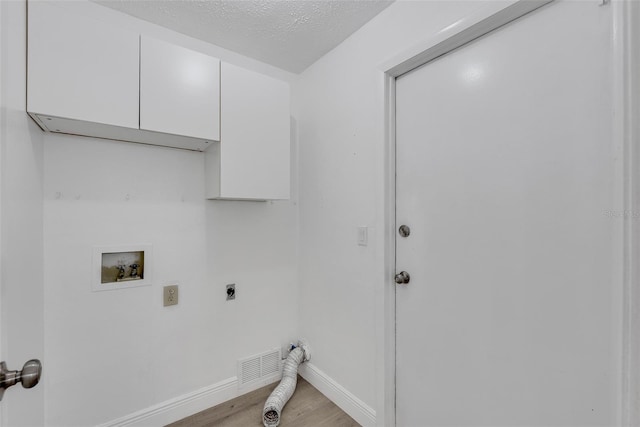 washroom featuring electric dryer hookup, visible vents, cabinet space, baseboards, and hookup for a washing machine