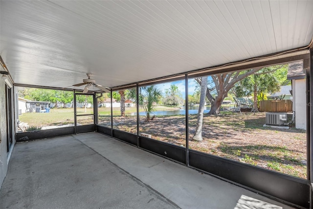 unfurnished sunroom featuring a water view