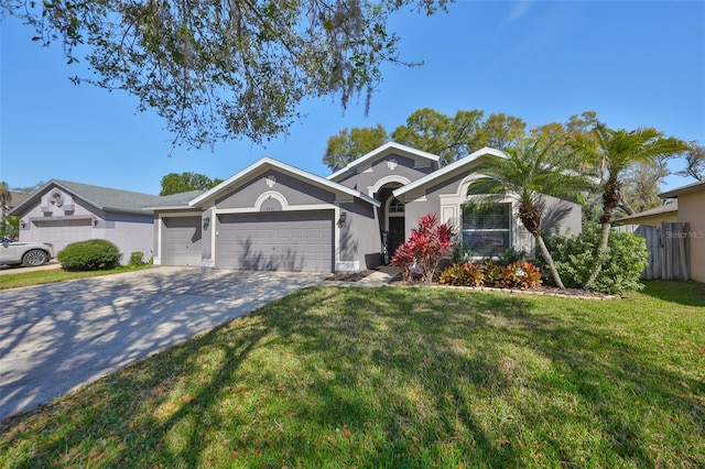 view of front facade with a front lawn, an attached garage, driveway, and stucco siding