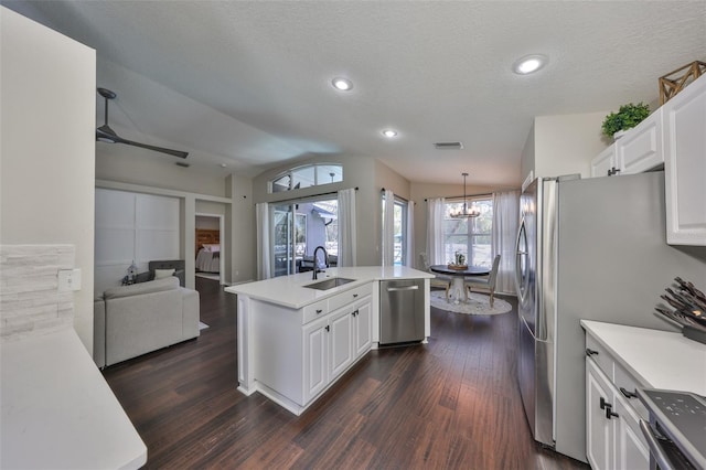 kitchen with open floor plan, light countertops, an island with sink, appliances with stainless steel finishes, and a sink