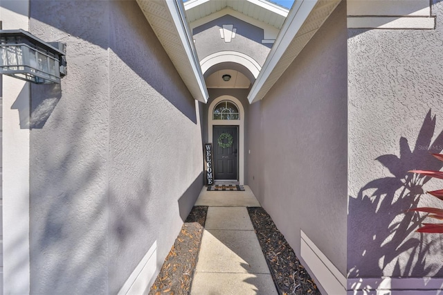 entrance to property with stucco siding