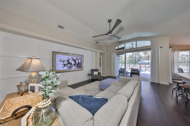 living room featuring visible vents, dark wood-style floors, baseboards, lofted ceiling, and ceiling fan