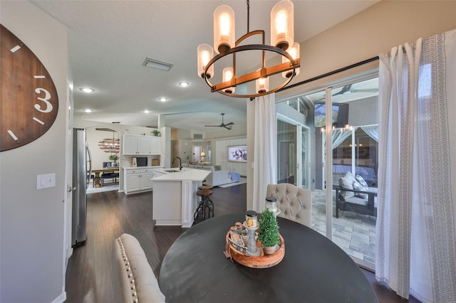 dining room featuring visible vents, dark wood-style floors, ceiling fan with notable chandelier, recessed lighting, and arched walkways