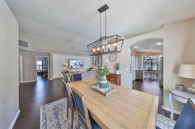 dining area with arched walkways, visible vents, baseboards, and dark wood-style floors