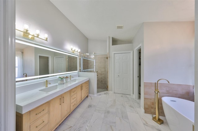 bathroom featuring double vanity, a freestanding bath, a sink, a shower stall, and marble finish floor