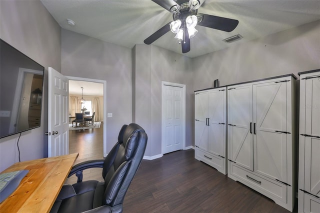 office with ceiling fan, visible vents, baseboards, and dark wood finished floors