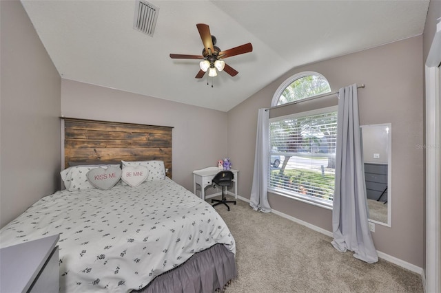 bedroom featuring lofted ceiling, light colored carpet, visible vents, and baseboards