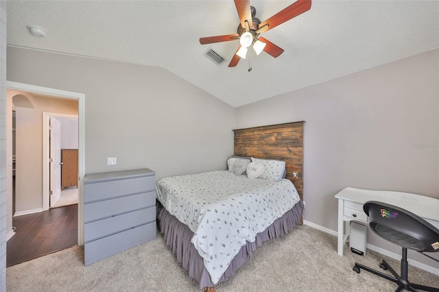 carpeted bedroom with visible vents, a ceiling fan, baseboards, arched walkways, and lofted ceiling