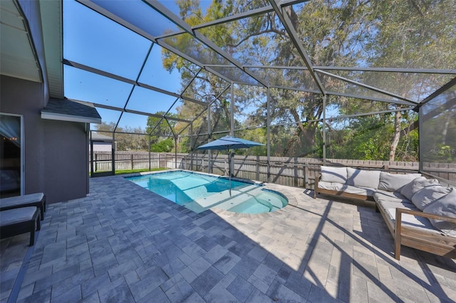 view of pool featuring an outdoor living space, a patio, a fenced backyard, glass enclosure, and a fenced in pool