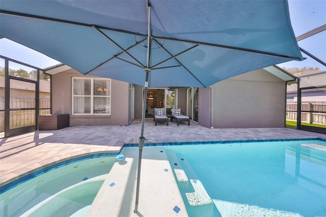 view of swimming pool with a fenced in pool, fence, a lanai, and a patio area