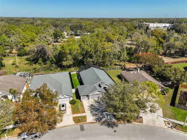 birds eye view of property with a view of trees