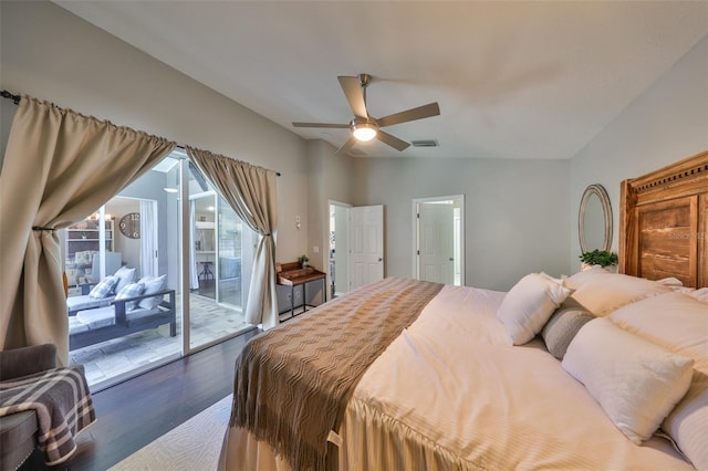 bedroom with access to exterior, visible vents, vaulted ceiling, wood finished floors, and a ceiling fan