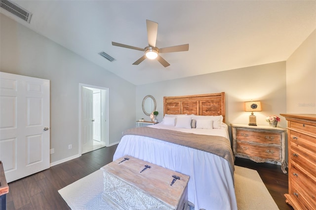 bedroom with visible vents, baseboards, dark wood finished floors, and vaulted ceiling