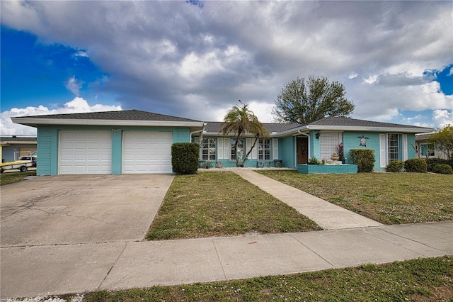 ranch-style home with an attached garage, driveway, and a front lawn