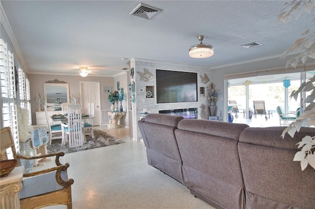 living room with visible vents, speckled floor, a textured ceiling, and crown molding