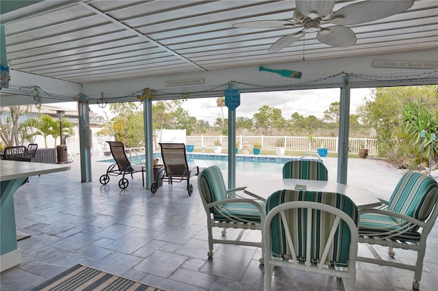 view of patio / terrace featuring ceiling fan, a fenced in pool, a fenced backyard, and outdoor dining space