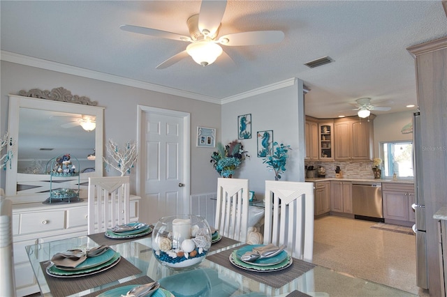 dining room with visible vents, a textured ceiling, and crown molding