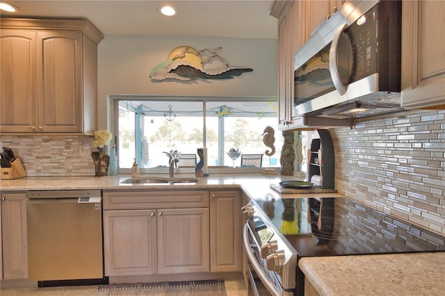 kitchen featuring a sink, decorative backsplash, appliances with stainless steel finishes, and recessed lighting