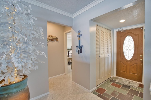 entryway with baseboards, a textured ceiling, and ornamental molding