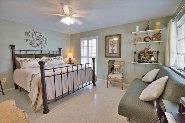 bedroom with a ceiling fan, speckled floor, and baseboards