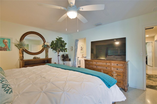 bedroom with ceiling fan, visible vents, baseboards, and ensuite bath