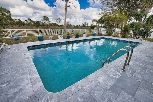 view of swimming pool with a fenced in pool, a patio, and fence