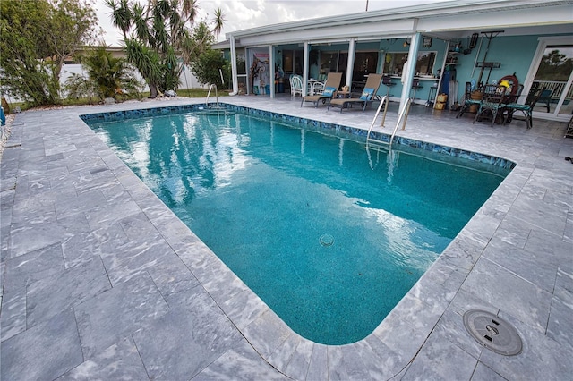 view of swimming pool featuring a fenced in pool and a patio