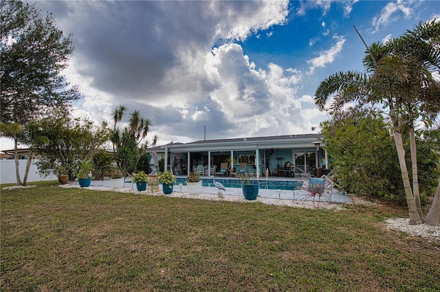 pool with a patio and a lawn