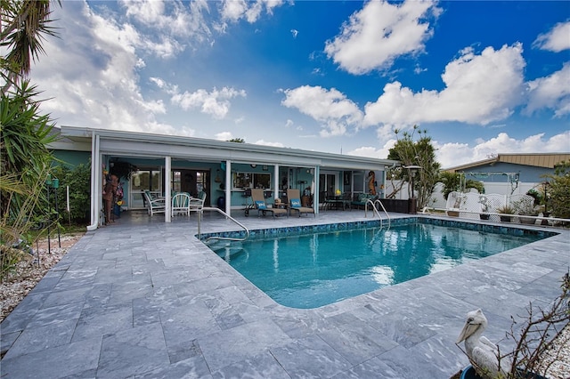 view of swimming pool with a fenced in pool, a patio, and fence