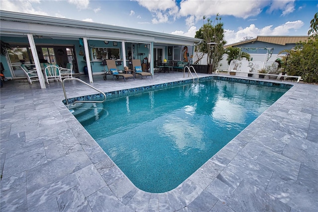 view of swimming pool with a patio, fence, and a fenced in pool