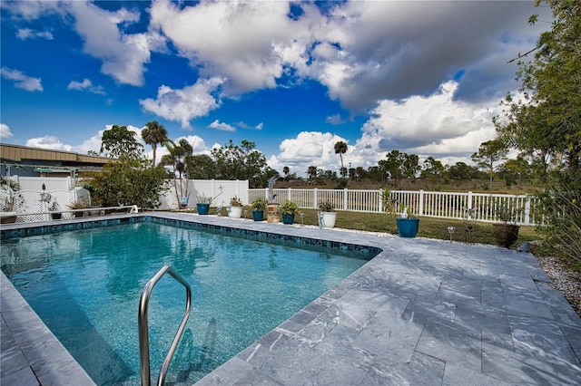 view of swimming pool featuring a fenced in pool, a patio, and a fenced backyard