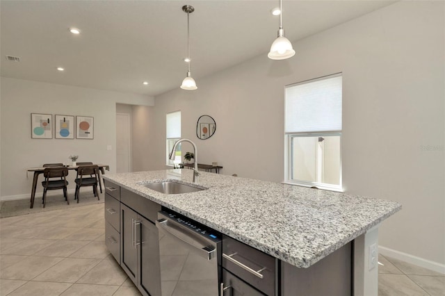 kitchen with visible vents, light tile patterned flooring, a sink, hanging light fixtures, and stainless steel dishwasher