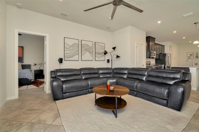 living area with light tile patterned floors, visible vents, recessed lighting, and a ceiling fan