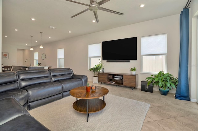 living room with light tile patterned floors, recessed lighting, baseboards, and ceiling fan