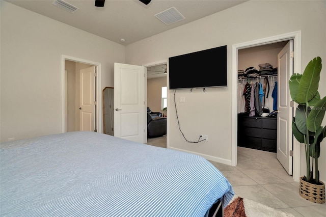 bedroom featuring a closet, visible vents, a spacious closet, and light tile patterned floors