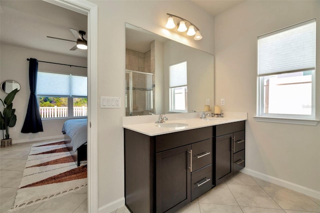 full bath featuring a sink, double vanity, a shower stall, and tile patterned flooring